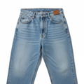 Baggy jeans laid flat on white background